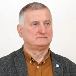 Dr. Rimantas Bakas, konferencijos moderatorius ir Lietuvos termoinžinerijos asociacijos prezidentas. Portretinė nuotrauka &ndash; vyresnio amžiaus vyras su trumpais plaukais, dėvintis &scaron;varką ir mar&scaron;kinius. Jis žvelgia &scaron;iek tiek į &scaron;oną. Fonas &ndash; &scaron;viesus.